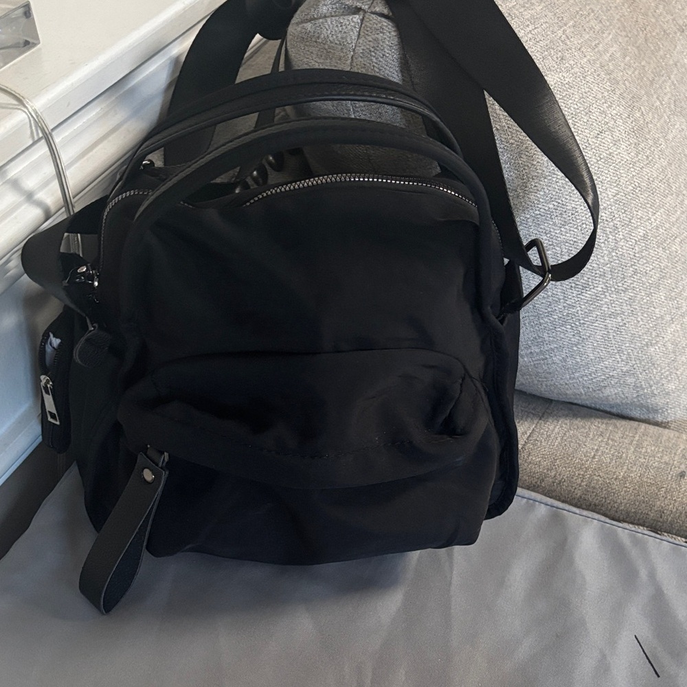 Perfect size black bag . Two ways to carry. Gorgeous silver hardware. New
